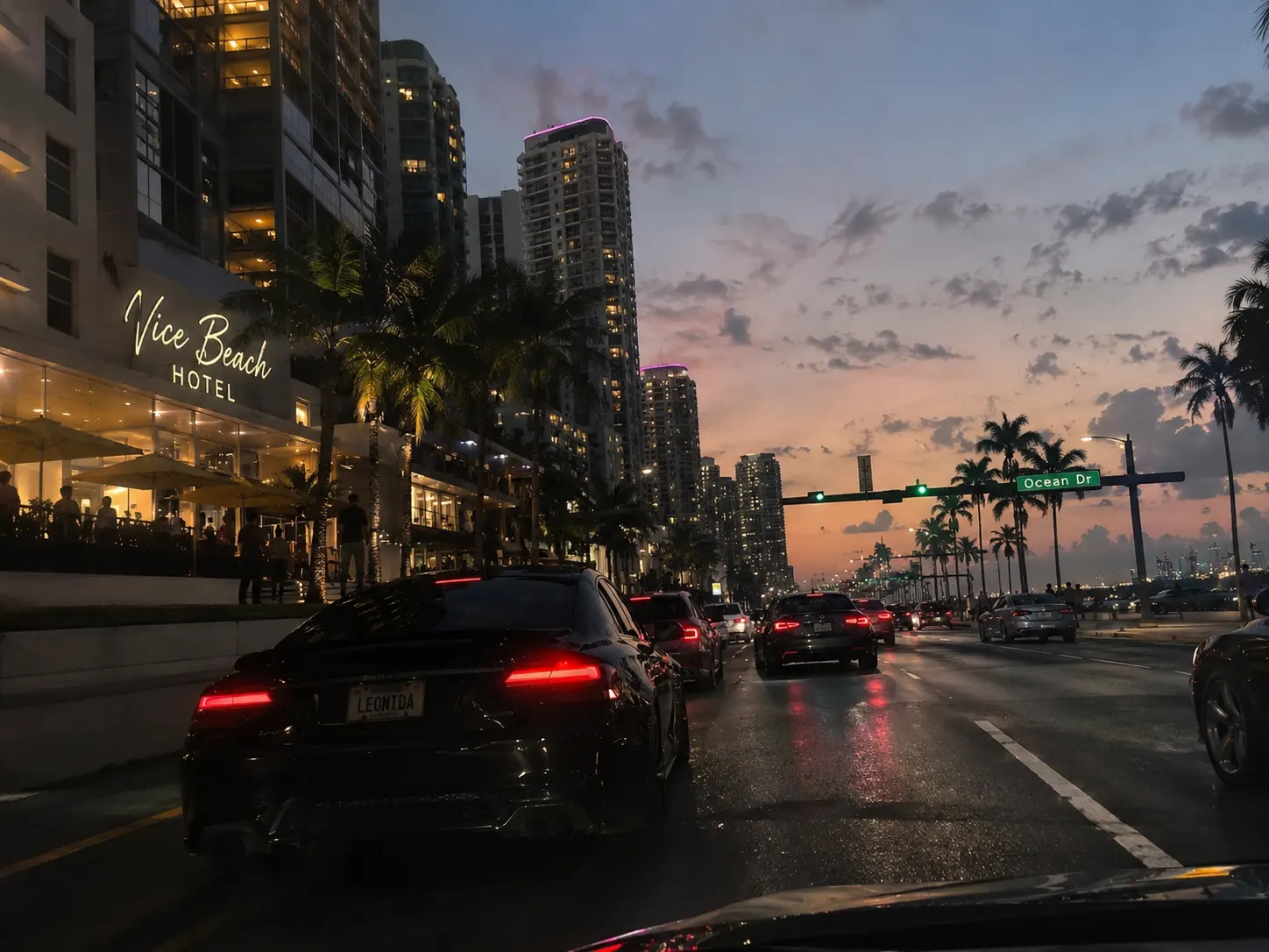 Hotel on Ocean Drive at dusk with a classic car