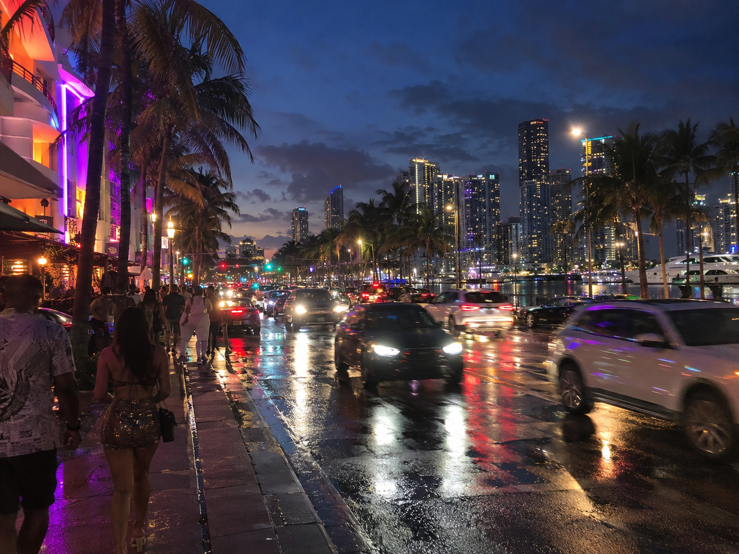 Neon-lit strip at night with rain and palm reflections on the wet road